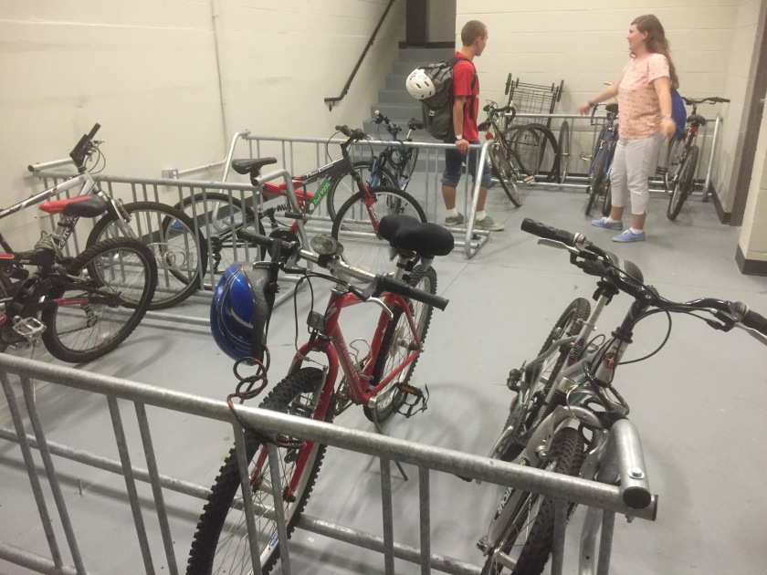 UB students Scott Thomsen and Christine Wertz check out the bike room that provides longterm and overnight bicycle storage for residents of the Varsity, near campus. How many students living in midtown don’t have access to a bike room? Photo Credit: Laura Melamed